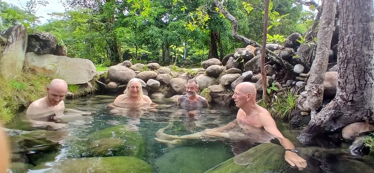 Friends gathered in a Caldera hot spring pool