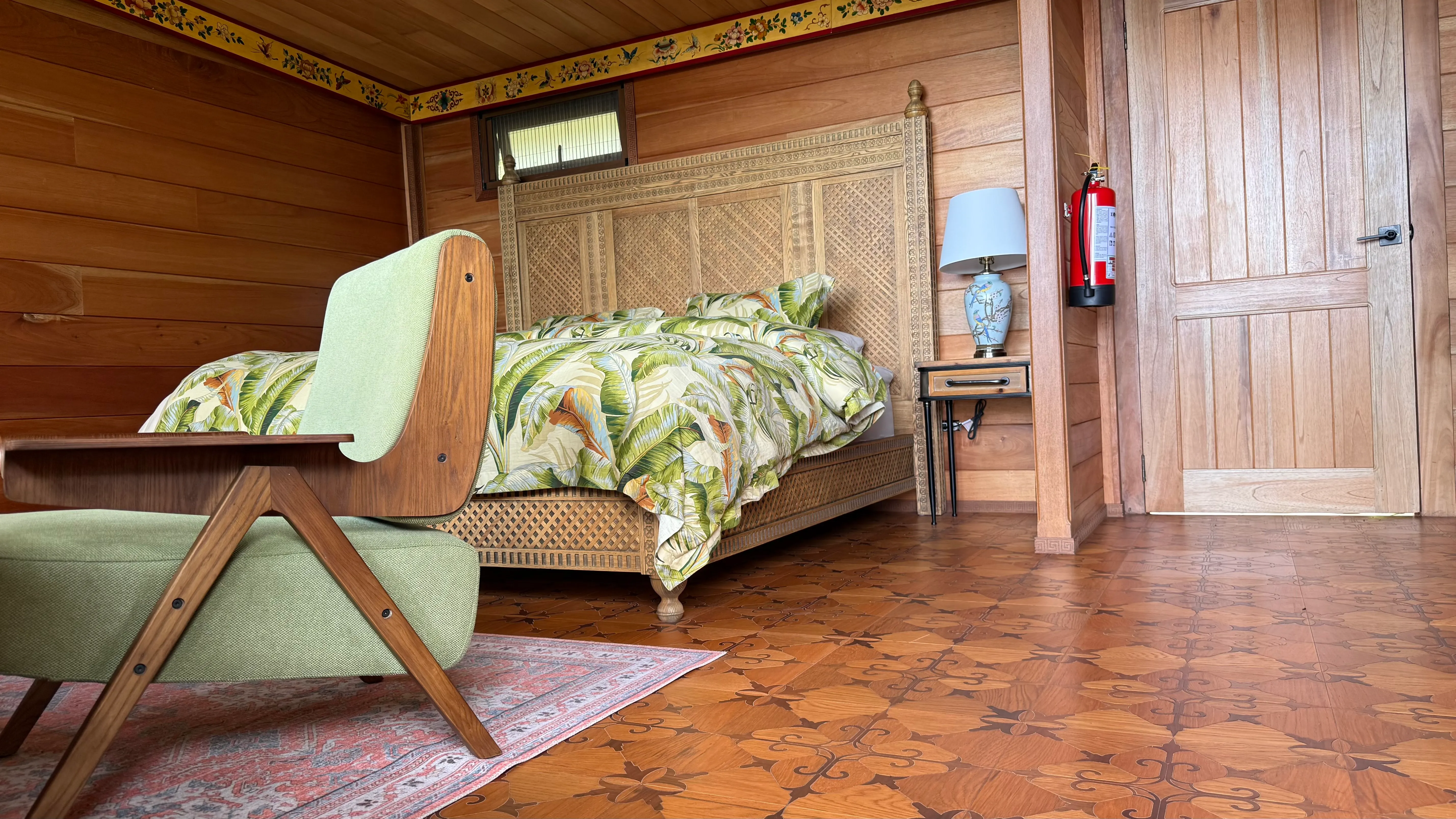 Cabin Jaguar bedroom with carved bed and patterned tile floor